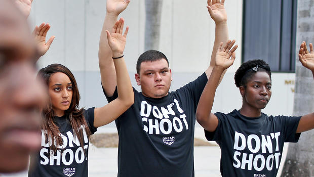 3034486-poster-p-1-hands-up-dont-shoot.j