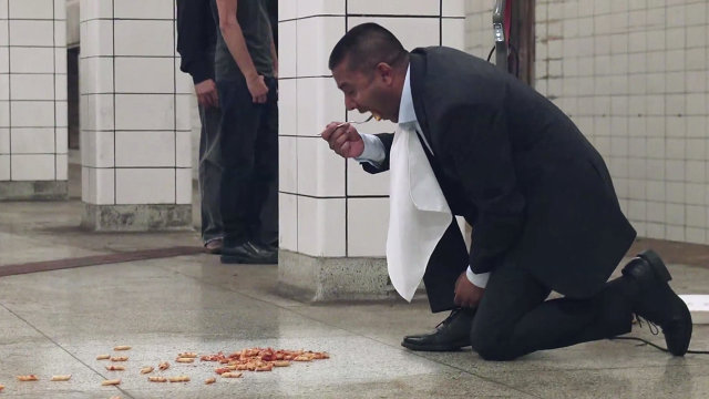 picture of Ravi Dalchand having food on the floor at Toronto's busiest subway station